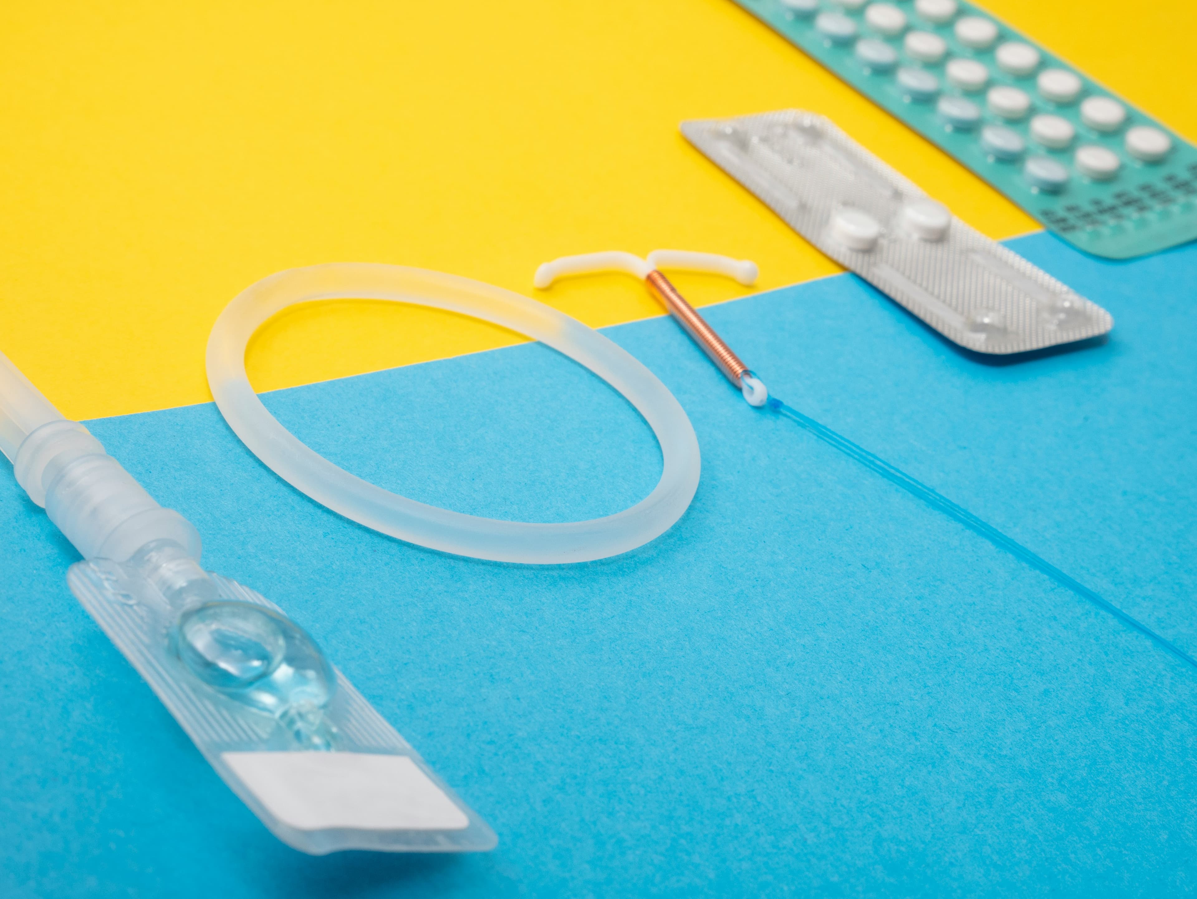 Contraceptive and hormonal therapy devices on a colourful background