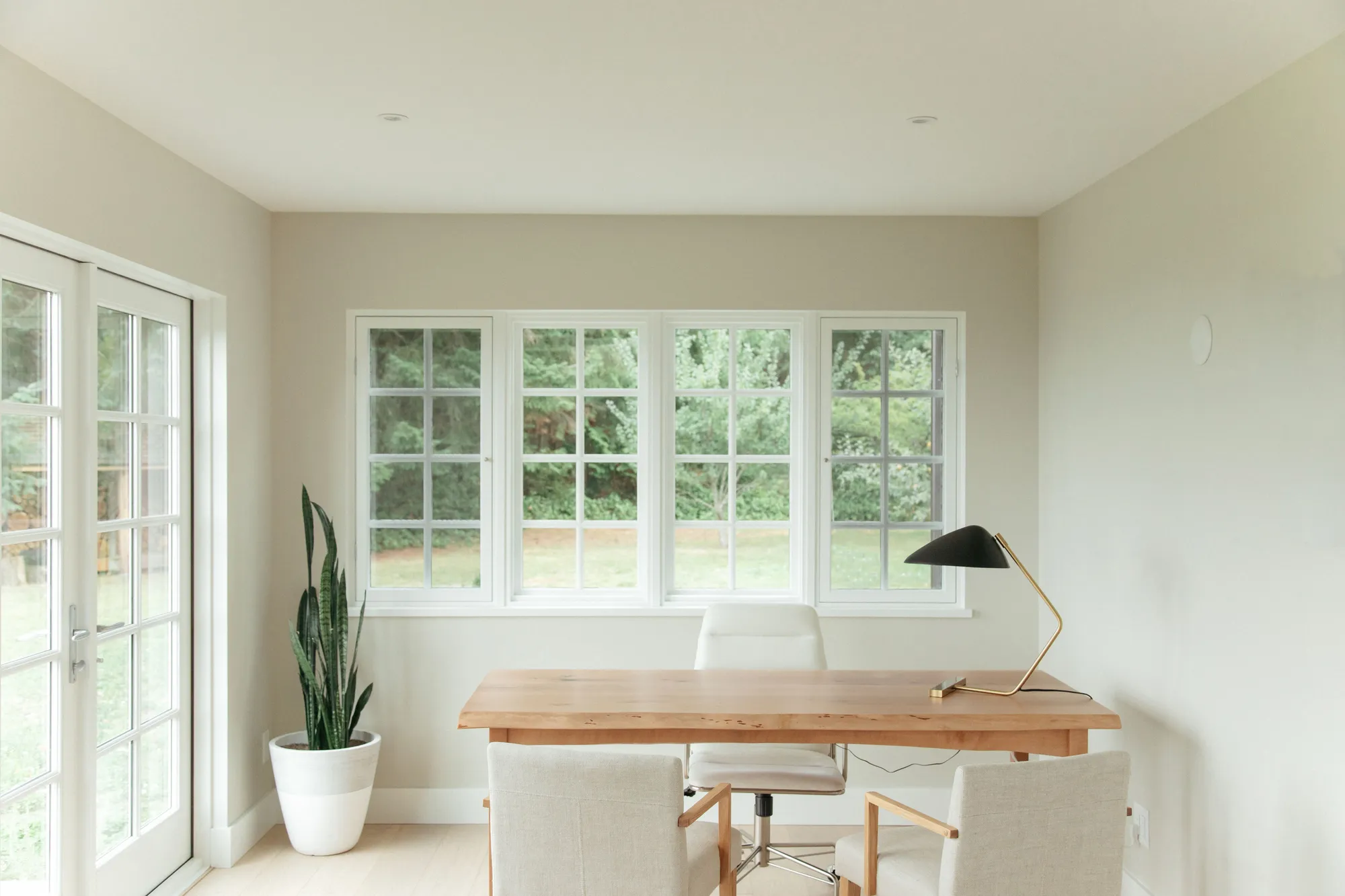 Bright office with wooden desk and garden view