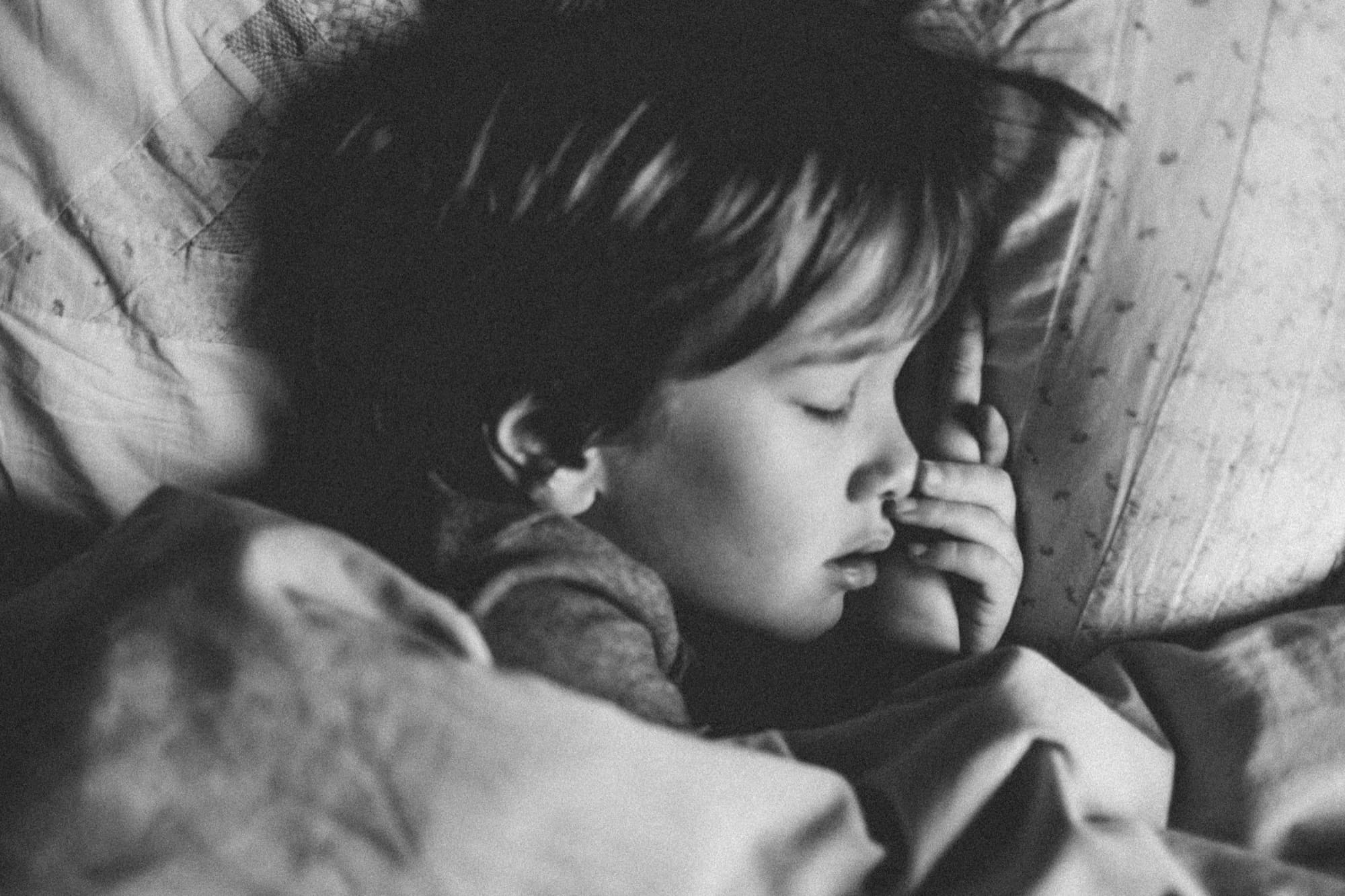 Young child sleeping peacefully, black and white